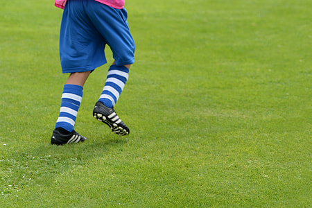 soccer player standing on grass field thumbnail