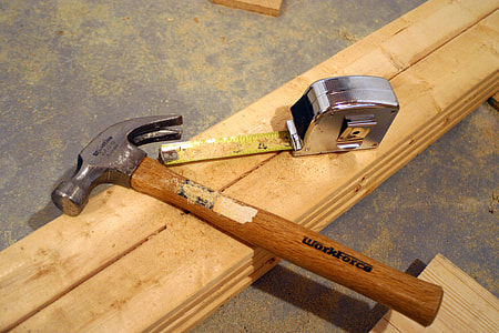 brown Work hammer beside measuring tape thumbnail