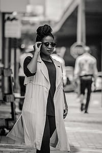 grayscale photography of woman walking on street thumbnail