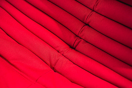 Folded sweaters and fabrics stacked on shelves thumbnail