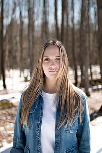 shallow focus of woman near bare trees during daytime thumbnail