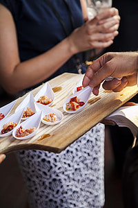 person picked cooked dish on serving board close-up photo thumbnail