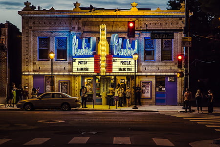 people walking on street beside store during nighttime thumbnail