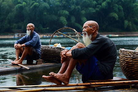 white beaded man wearing black top and blue short while ride-on bamboo thumbnail