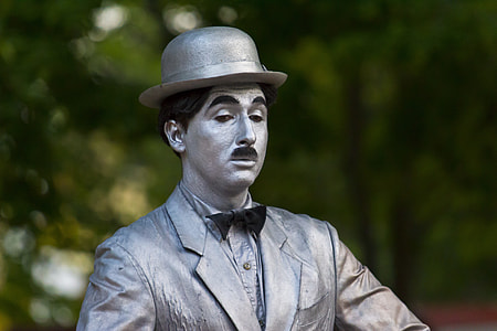 male statue wearing bowler cap selective focus photography thumbnail