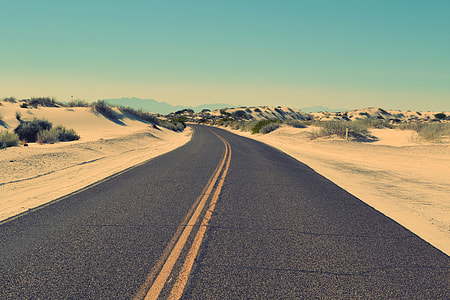 gray concrete road near mountain thumbnail