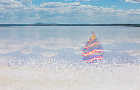 hot air balloon over body of water thumbnail