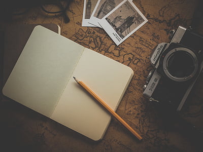 open blank notebook page with pen beside camera thumbnail