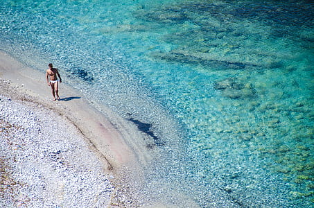 man standing on shore thumbnail
