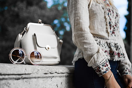 white leather 2-way bag beside woman in gray blouse thumbnail
