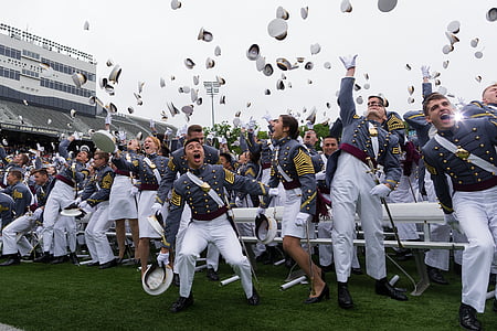 new graduates throwing their hats on the air during daytime thumbnail