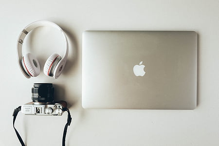 silver MacBook; white Beats by Dr. Dre headphones; silver and black camera thumbnail