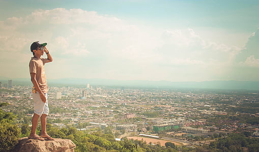 man looking the overview of city thumbnail