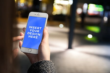 Free PSD Mockup. Girl uses her smartphone in the city at night thumbnail