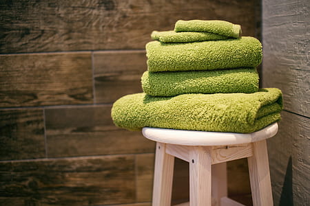 several green towels on bar stool thumbnail
