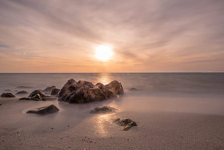 rock formation on seashore during goldenhour thumbnail