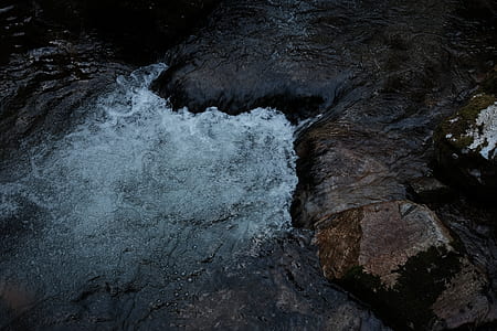 brown rock beside body of water thumbnail