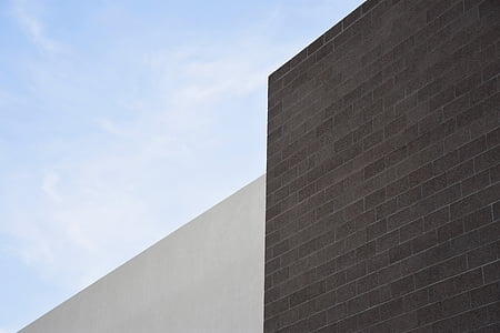 brown concrete bricked wall under cloudy sky thumbnail