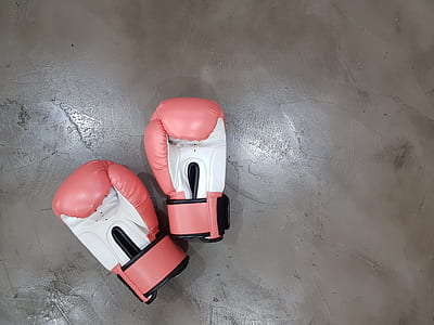pair of pink-and-white boxing gloves on floor thumbnail