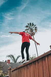 man standing on brown fence thumbnail