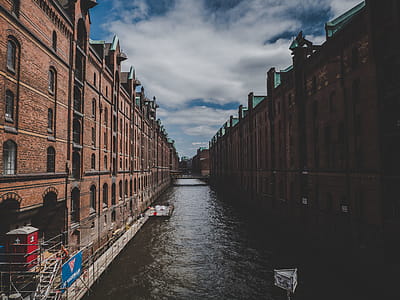Canal Between Two Brown Bricked Buildings thumbnail
