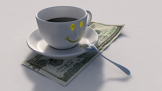 white ceramic mug in top of banknote thumbnail