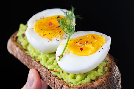 Sliced Egg on Top of Green Salad With Bread thumbnail