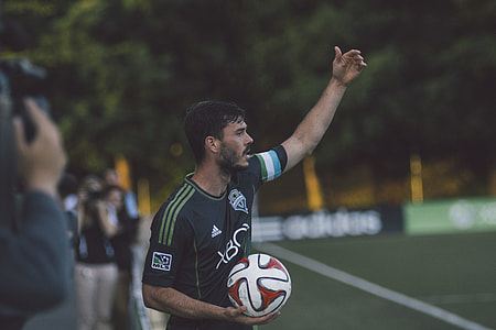 football player holding ball thumbnail