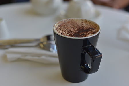 coffee on black ceramic mug on top of table thumbnail