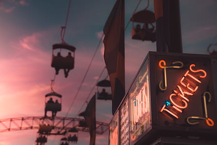 low angle photo of tickets light signage under cable carts thumbnail