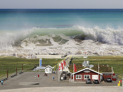 aerial photo of tsunami across grass field and building thumbnail