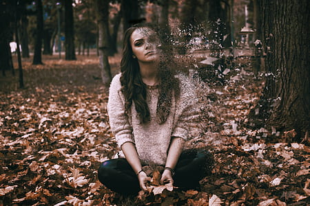 woman sitting on dried leaf thumbnail