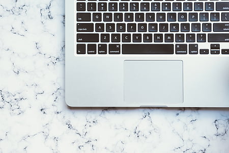 MacBook on marble-top surface thumbnail