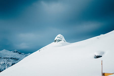 mountain filled of snow under blue sky thumbnail