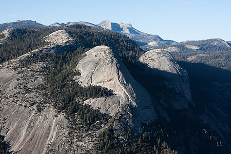 hills covered with trees under clear sky thumbnail