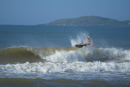 man surfing during daytime thumbnail