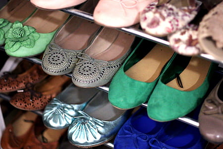 pair of shoes on gray rack thumbnail