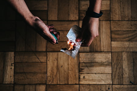 person burning white paper thumbnail