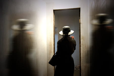 woman wearing hat standing near opened door thumbnail
