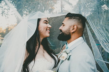 newly wedded couple under veil thumbnail