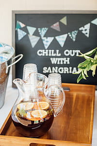 clear glass pitcher with lemonade with cups on tray thumbnail