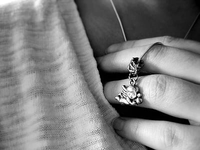 grayscale photography of person wearing of silver-colored ring thumbnail