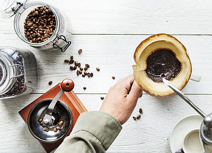 flay-lay photography of person holding mug on table thumbnail