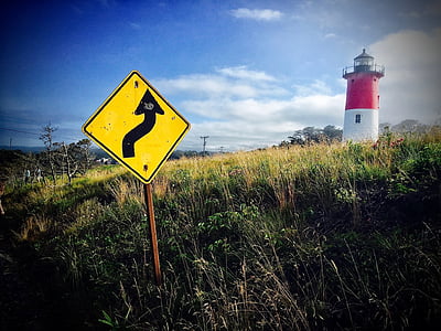 signage on grass field near lighthouse thumbnail