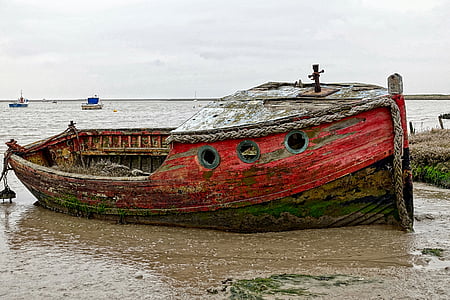 red and brown ship on seashore thumbnail
