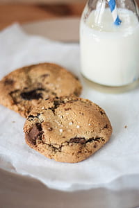 two chocolate cookies beside bottle thumbnail