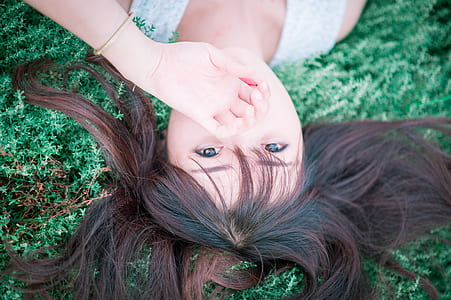 top view of a woman lying on green grass thumbnail