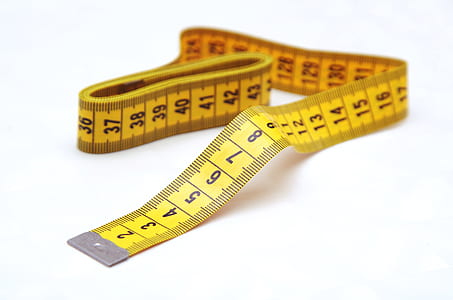 view of yellow tape measure on white surface thumbnail