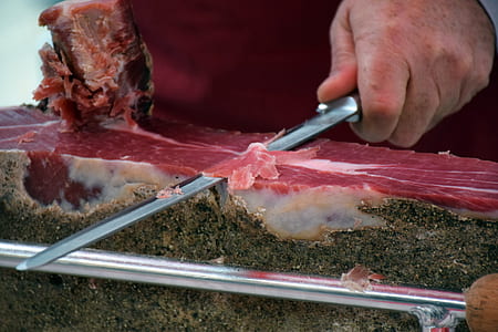 selective focus photo of man slicing meat thumbnail