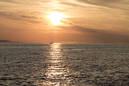 sun rays reflects on calm body of water thumbnail